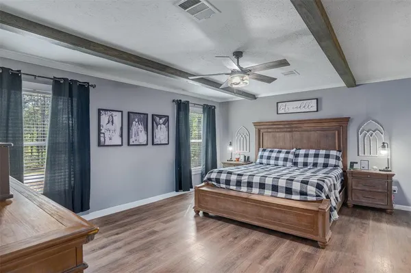 a bedroom with a bed next to a window with the outer view