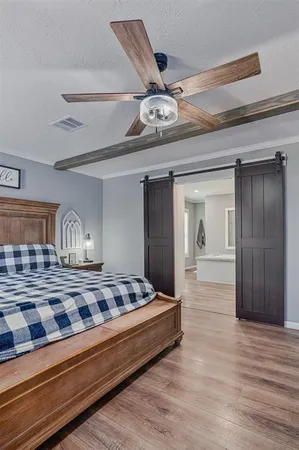 a view of bedroom with wooden floor