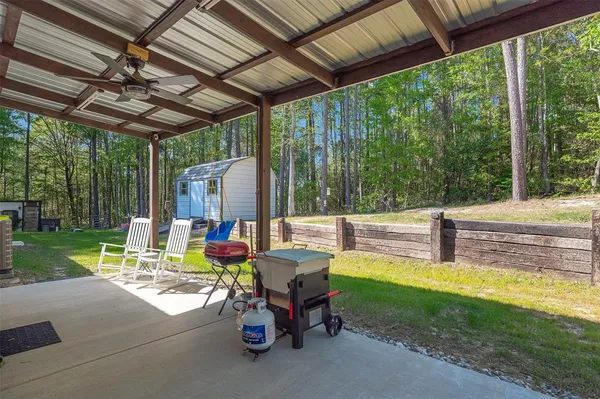 a view of a patio with a table chairs and a backyard