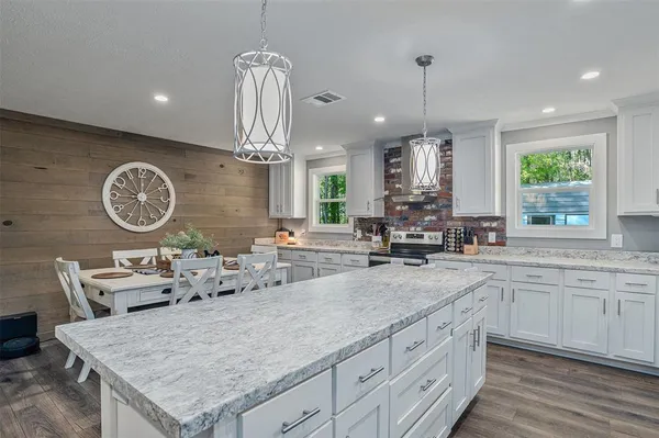 a kitchen with a table and a view of living room