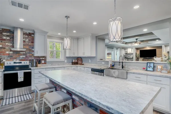a large kitchen with a table and chairs in it