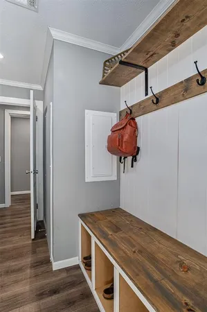 a kitchen with a stove and a wooden floor