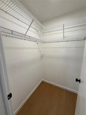 a view of a patio with couches table and chairs under an umbrella