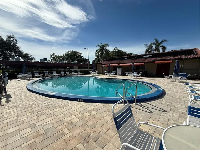 a view of a swimming pool with outdoor seating