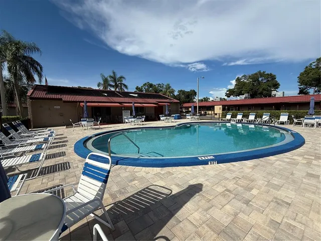 a view of a patio with a table and chairs and floor to ceiling window