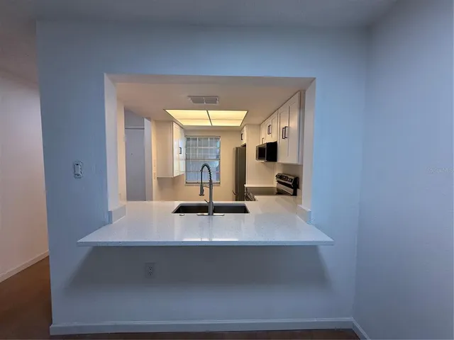 a view of kitchen with living room