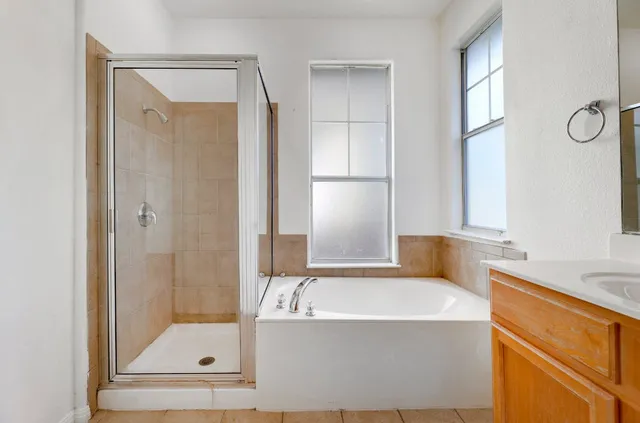 a bathroom with a tub and shower