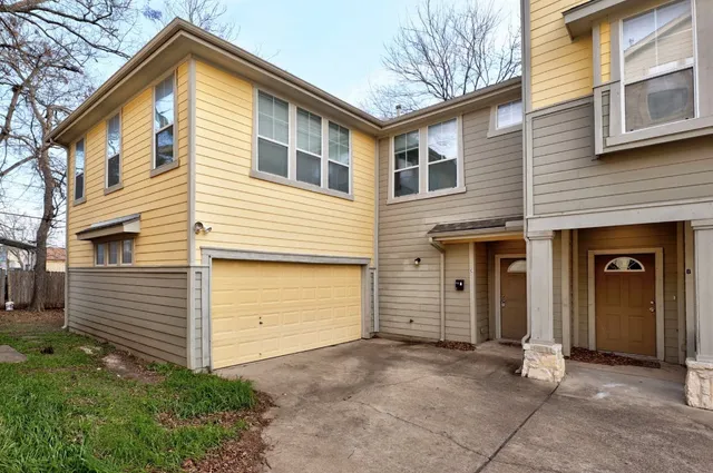 a view of a house with a yard and garage