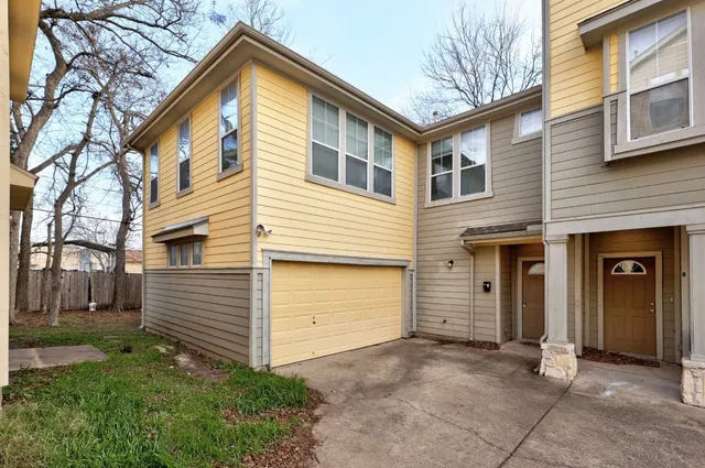 a view of a house with a yard and garage