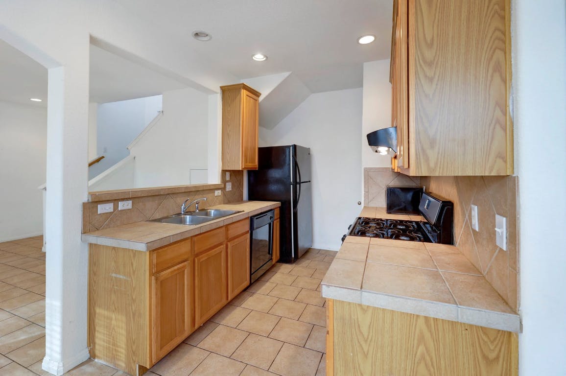 710 Franklin Boulevard, Unit C Austin, TX 78751 - Photo 9 of 29 a kitchen with a stove a refrigerator and a sink