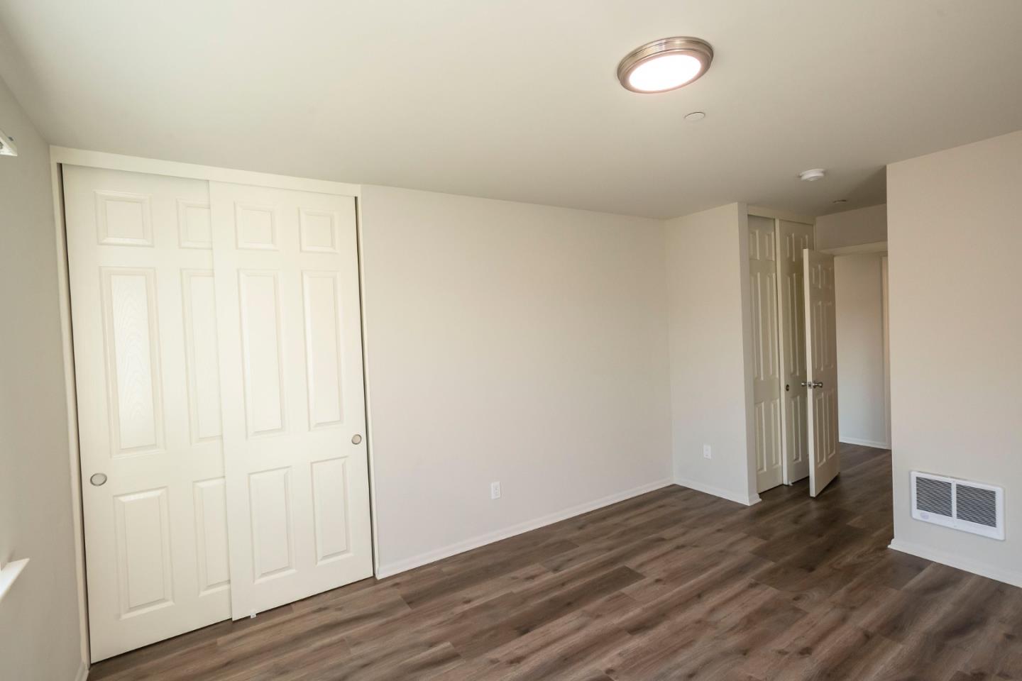 1007 Hemlock Avenue Millbrae, CA 94030 - Photo 14 of 34 an empty room with wooden floor and windows