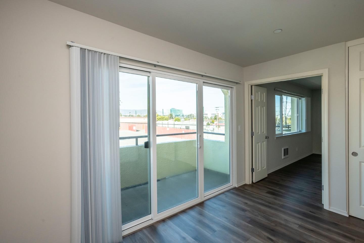 1007 Hemlock Avenue Millbrae, CA 94030 - Photo 15 of 34 a view of an empty room with wooden floor and a window