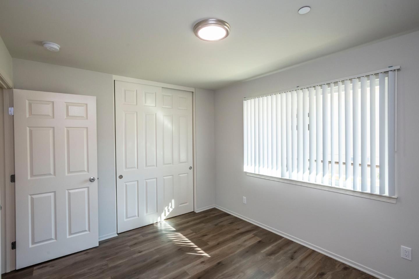 1007 Hemlock Avenue Millbrae, CA 94030 - Photo 18 of 34 a view of an empty room with wooden floor and a window