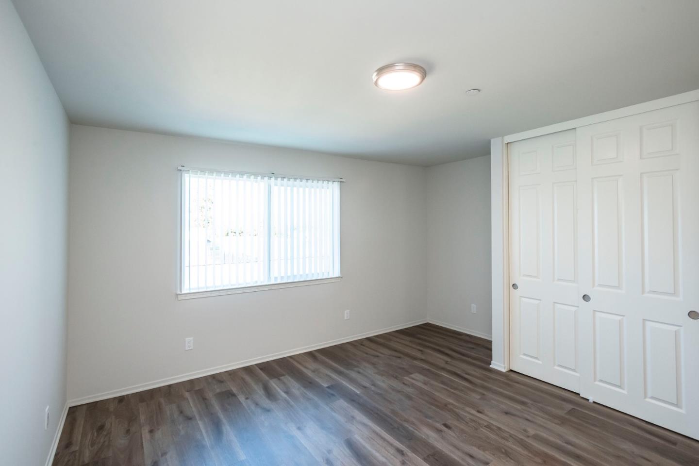 1007 Hemlock Avenue Millbrae, CA 94030 - Photo 19 of 34 an empty room with wooden floor and windows