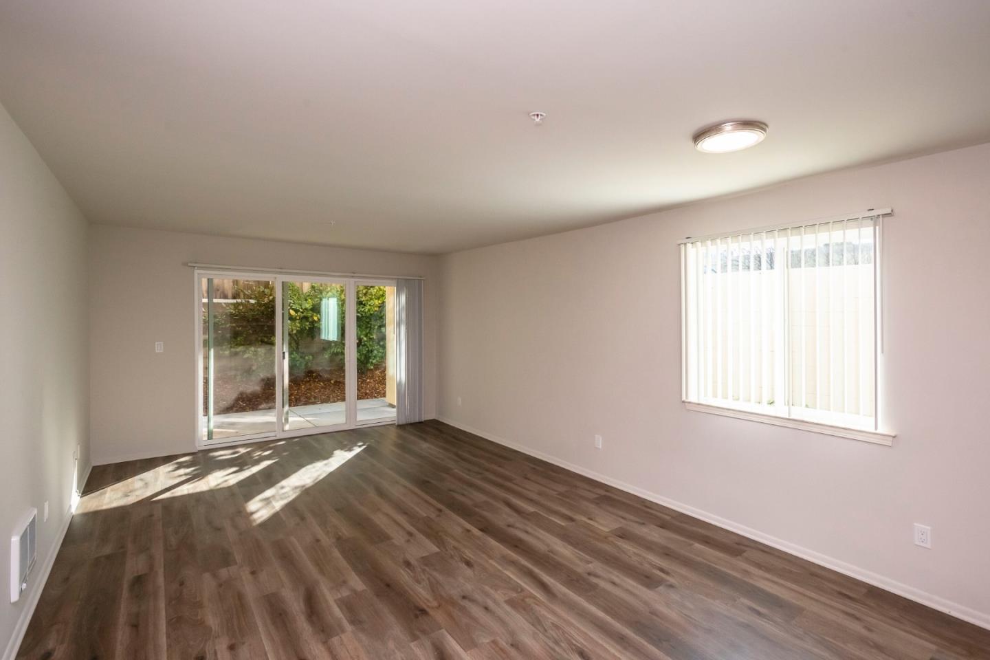 1007 Hemlock Avenue Millbrae, CA 94030 - Photo 5 of 34 a view of an empty room with wooden floor and a window