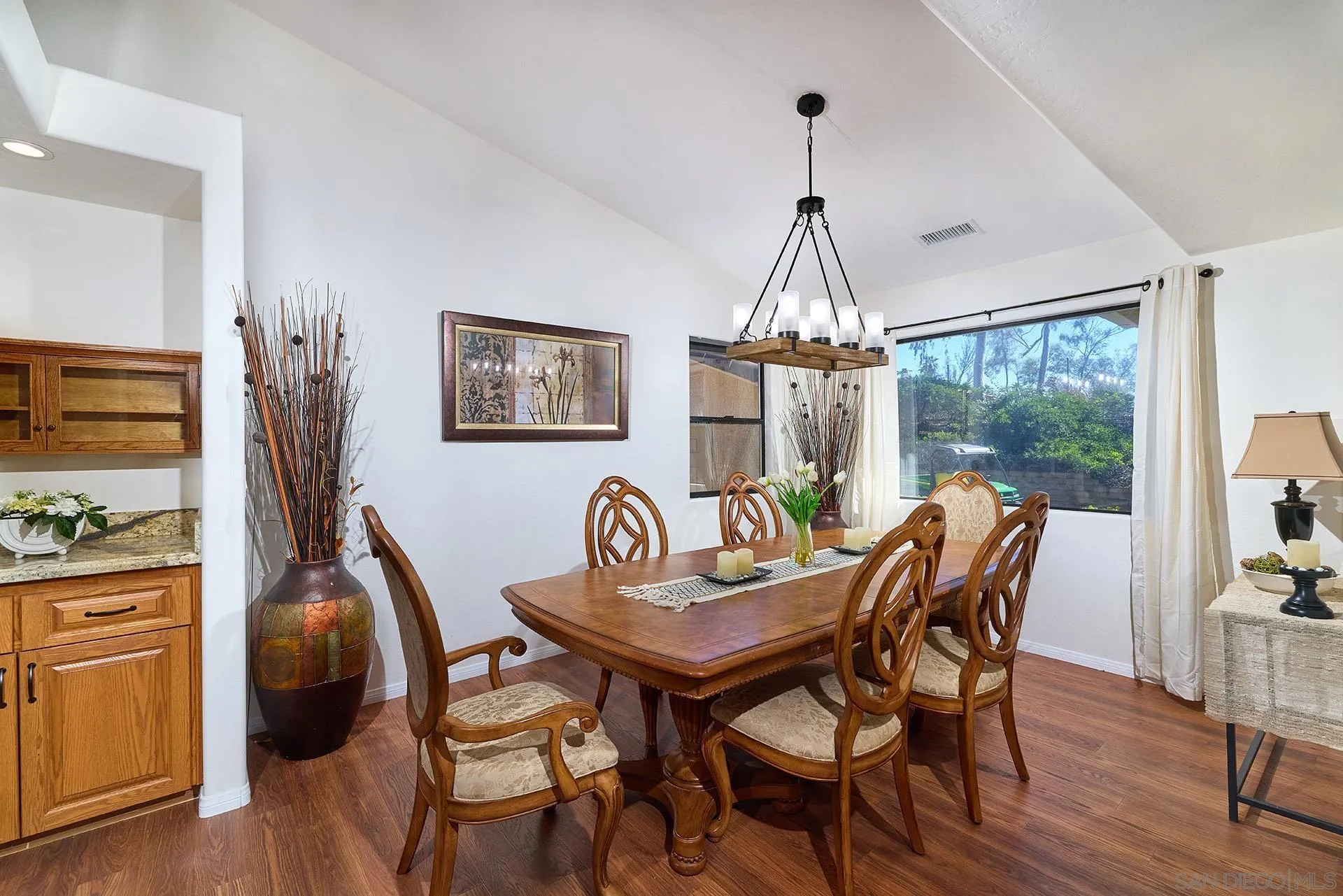 13588 McNally Road Valley Center, CA 92082 - Photo 11 of 43 a dining room with furniture a chandelier and wooden floor