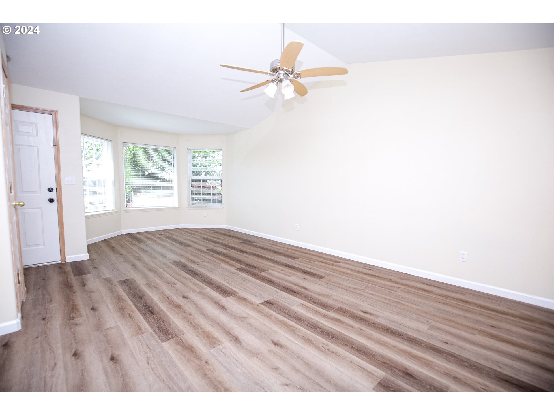 4112 South E Street Springfield, OR 97478 - Photo 6 of 21 a view of an empty room with wooden floor and a window