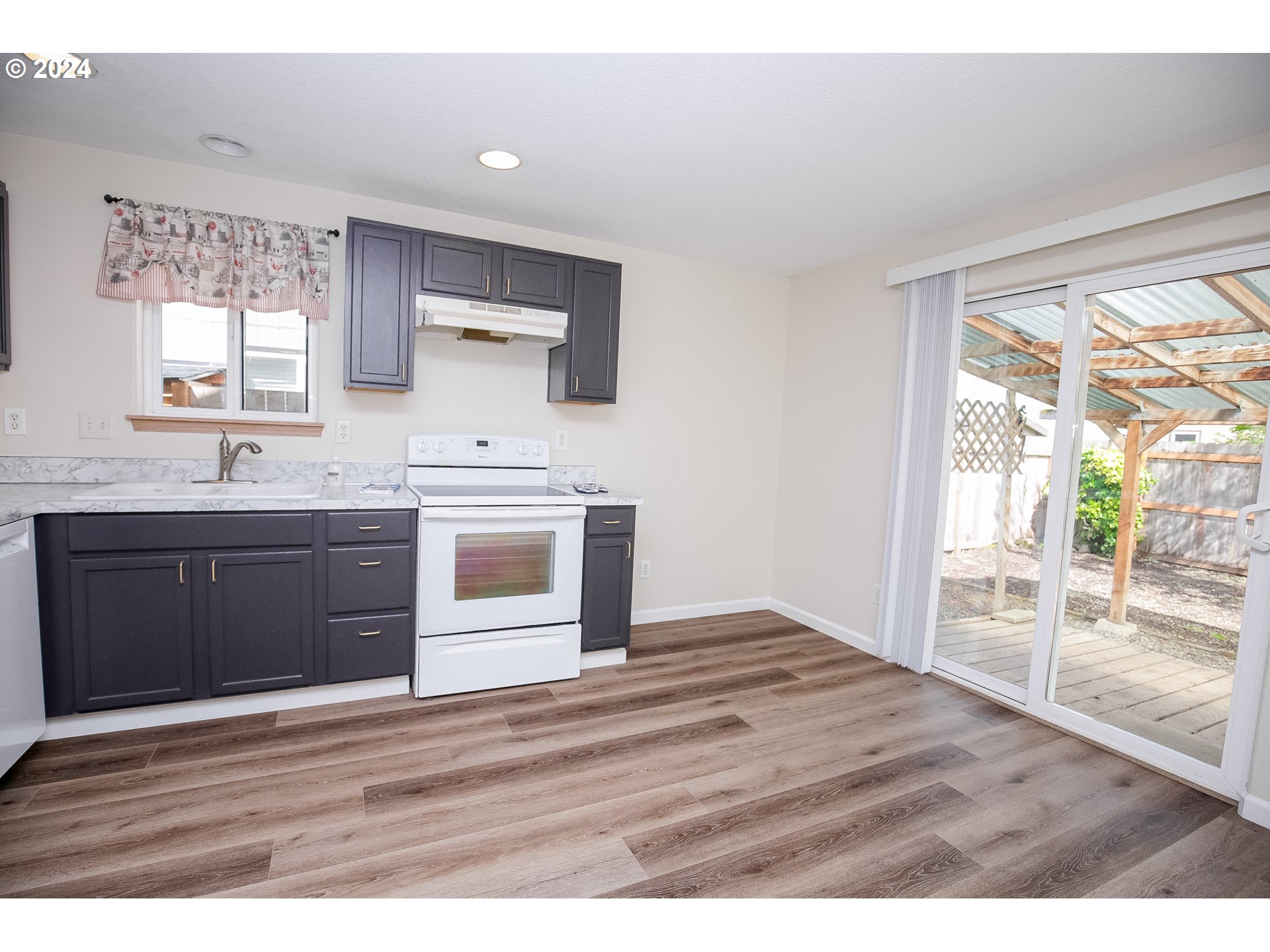 4112 South E Street Springfield, OR 97478 - Photo 10 of 21 a kitchen with stainless steel appliances granite countertop a stove a sink and a microwave