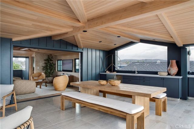a living room with furniture a flat screen tv and a large window