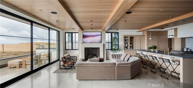 a living room with furniture fireplace and flat screen tv