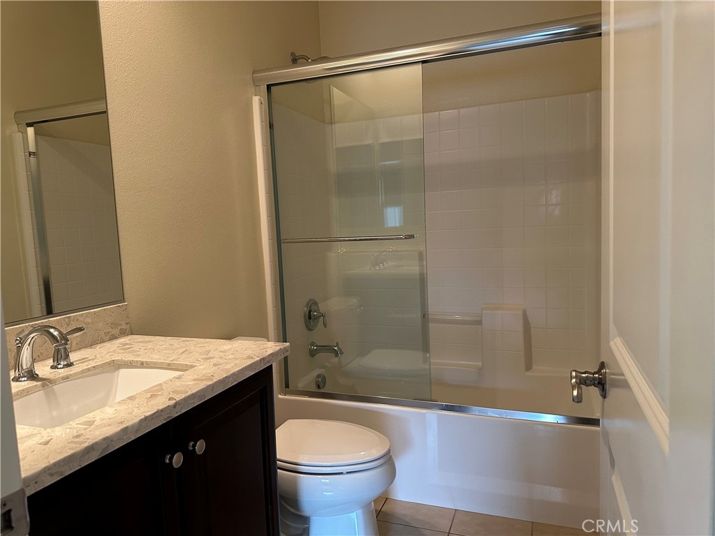 219 Wicker Irvine, CA 92618 - Photo 11 of 19 a bathroom with a granite countertop sink toilet and shower