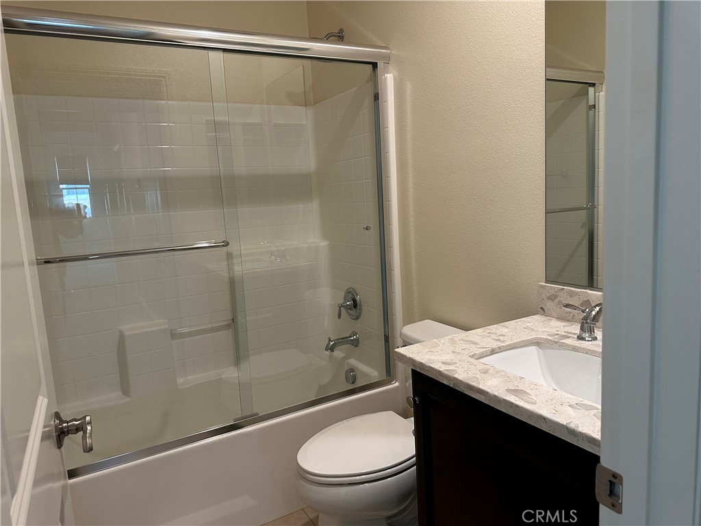 219 Wicker Irvine, CA 92618 - Photo 13 of 19 a bathroom with a granite countertop sink toilet and shower