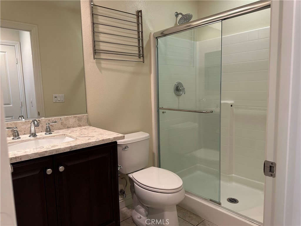 219 Wicker Irvine, CA 92618 - Photo 18 of 19 a bathroom with a sink a toilet and shower