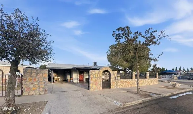 a front view of a building with tree s