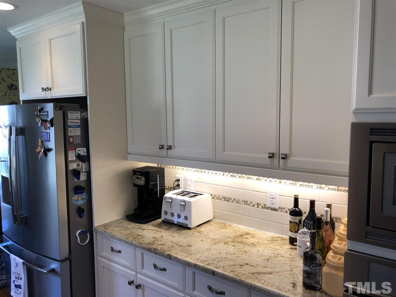 3907 Converse Drive Raleigh, NC 27609 - Photo 10 of 30 a kitchen with granite countertop a refrigerator a stove and a sink