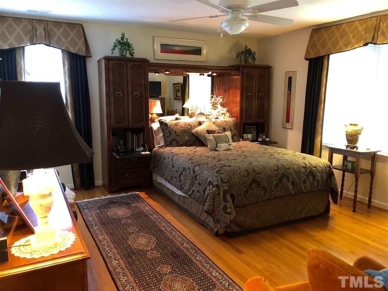 3907 Converse Drive Raleigh, NC 27609 - Photo 19 of 30 a bedroom with a bed window and dresser