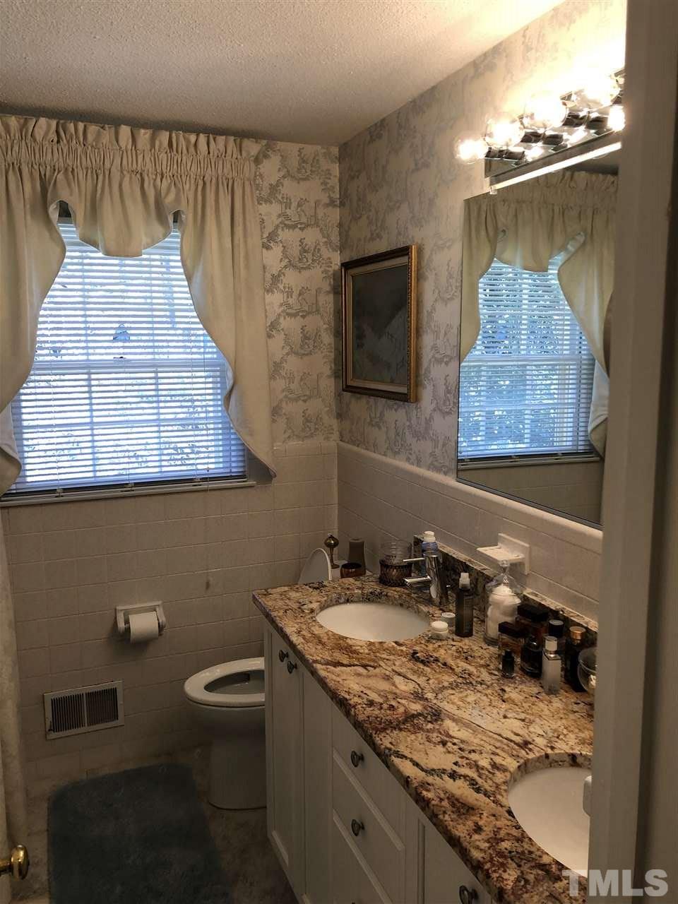3907 Converse Drive Raleigh, NC 27609 - Photo 21 of 30 a bathroom with a sink and a mirror