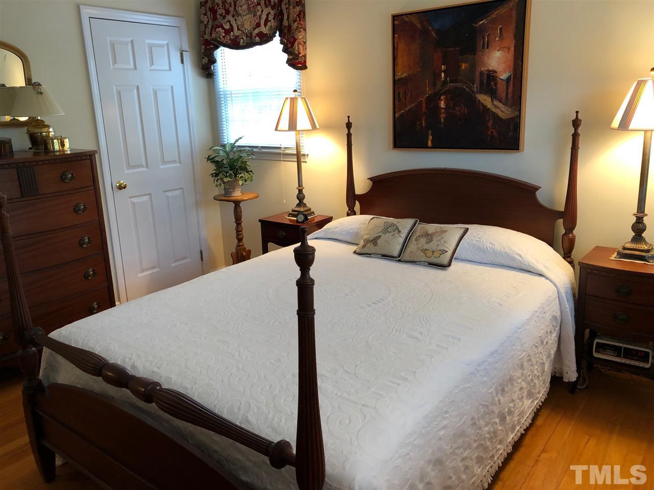 3907 Converse Drive Raleigh, NC 27609 - Photo 23 of 30 a bedroom with a bed and a lamp on dresser