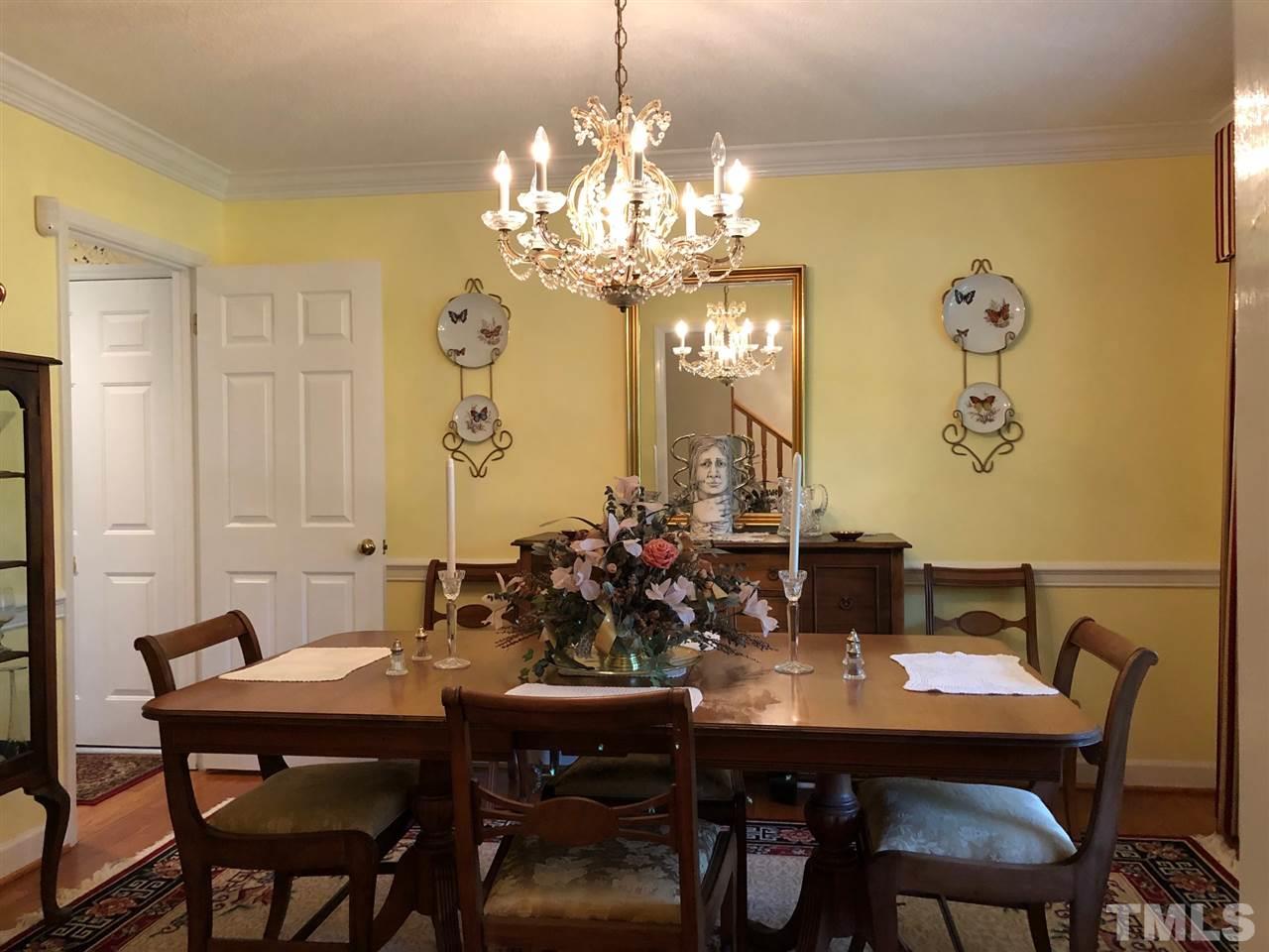 3907 Converse Drive Raleigh, NC 27609 - Photo 4 of 30 a view of a dining room with furniture and chandelier