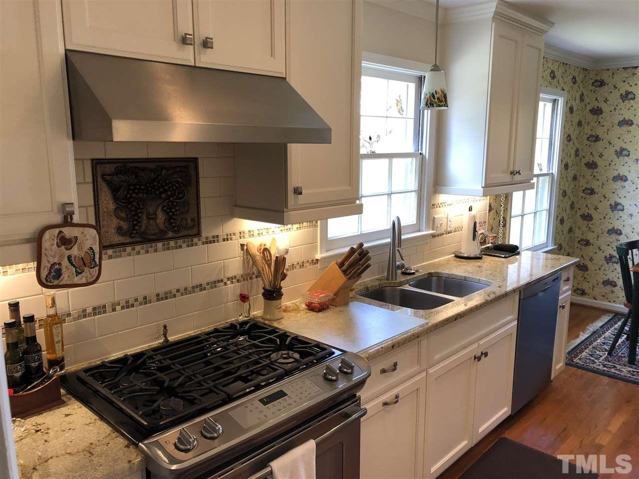 3907 Converse Drive Raleigh, NC 27609 - Photo 8 of 30 a kitchen with stainless steel appliances a stove a sink and a microwave