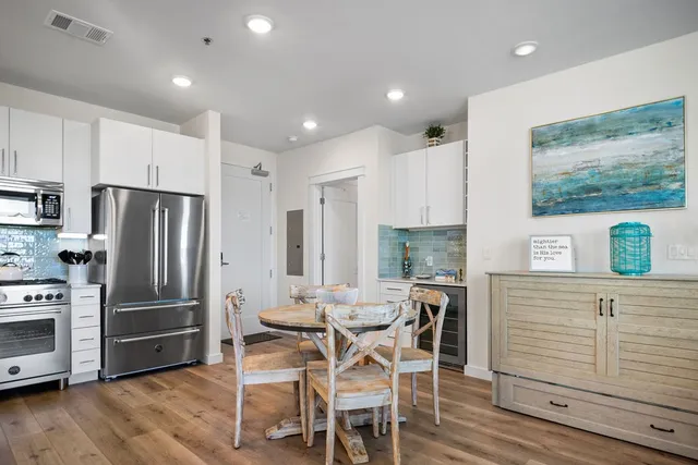 a kitchen with stainless steel appliances granite countertop a refrigerator and a stove top oven