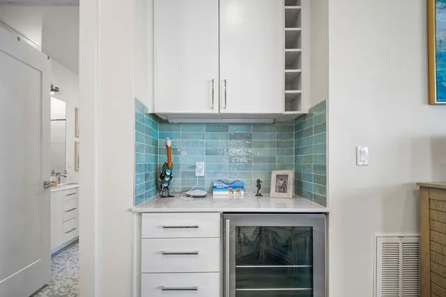 a kitchen with stainless steel appliances a cabinets and a potted plant