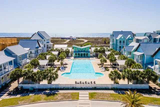 a view of a swimming pool and outdoor seating