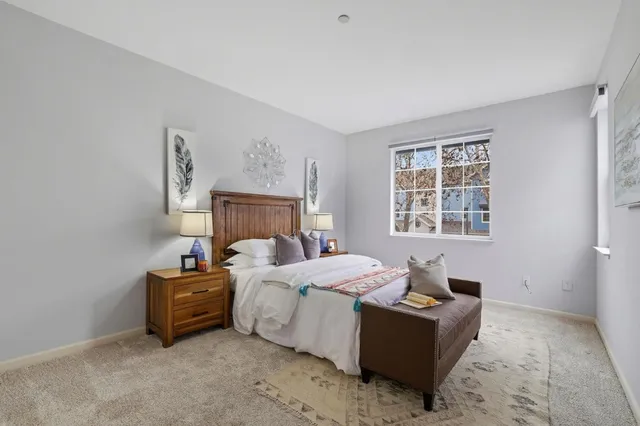 a bedroom with a bed and a window