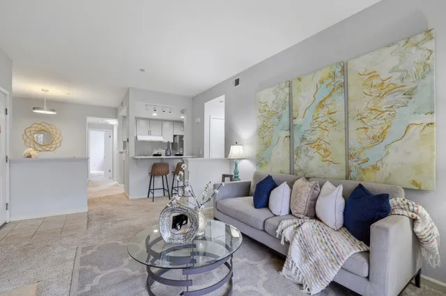 a living room with furniture and kitchen view