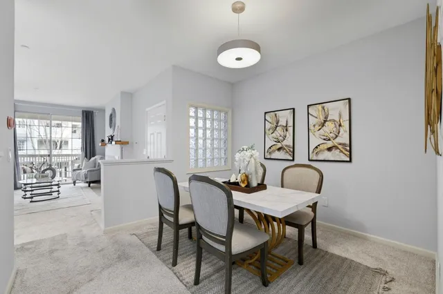 a view of a a dining room with furniture window and wooden floor