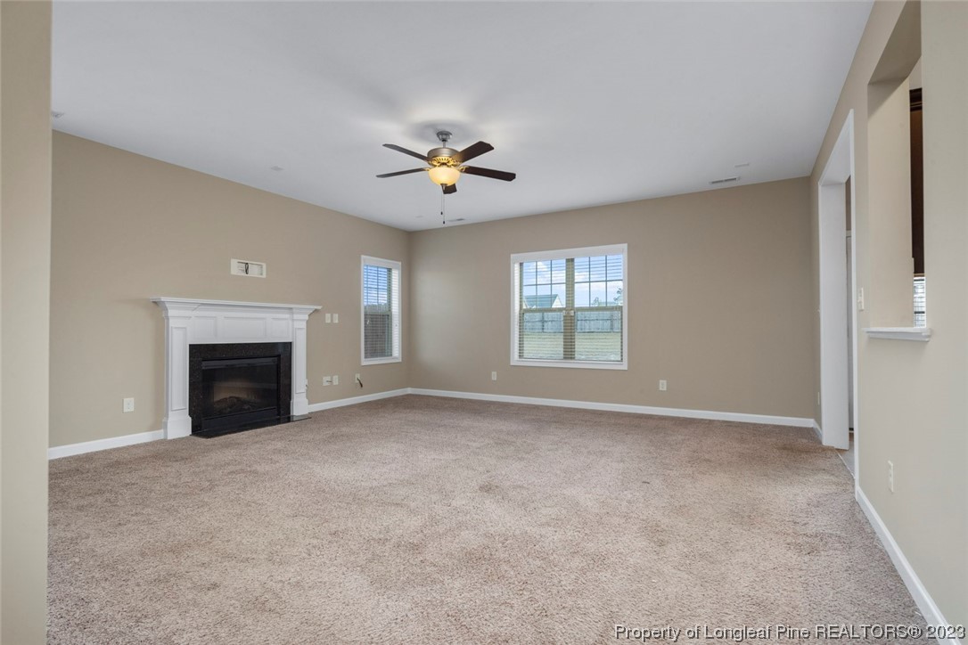 152 Copper Loop Sanford, NC 27332 - Photo 18 of 50 a view of an empty room with a fireplace