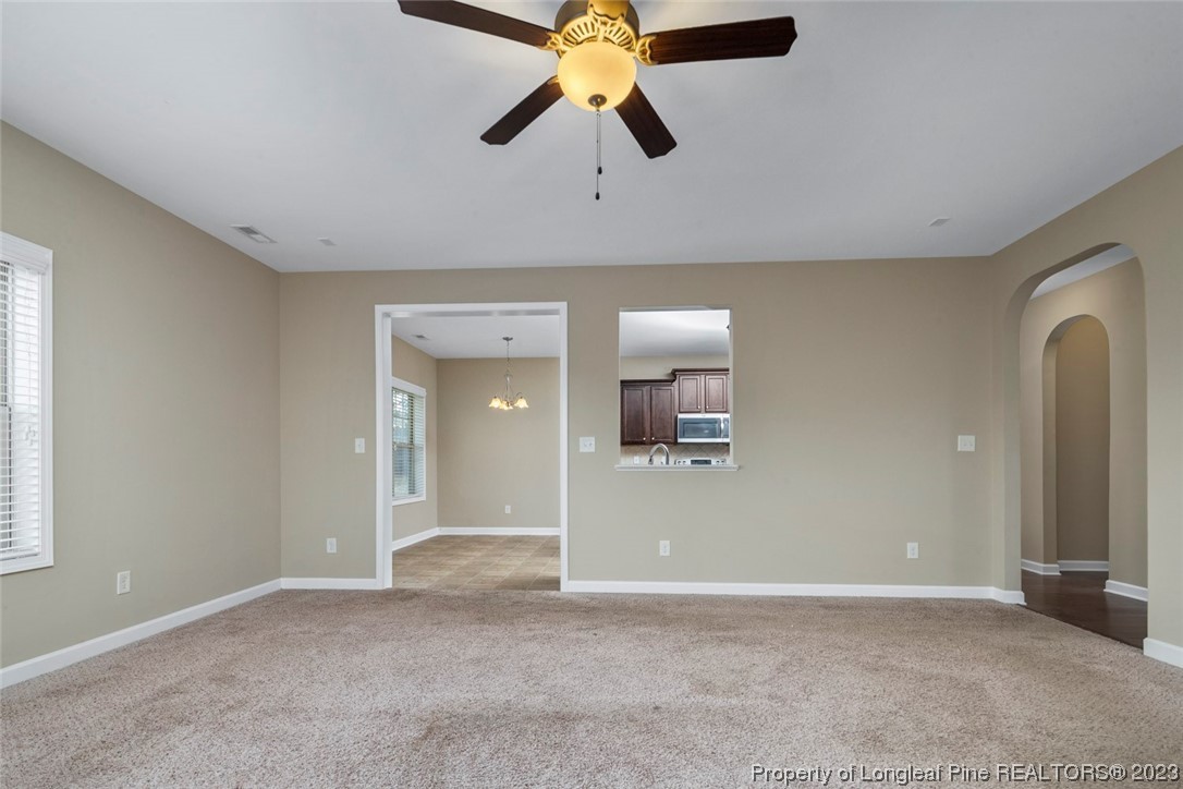 152 Copper Loop Sanford, NC 27332 - Photo 20 of 50 an empty room with chandelier fan and windows