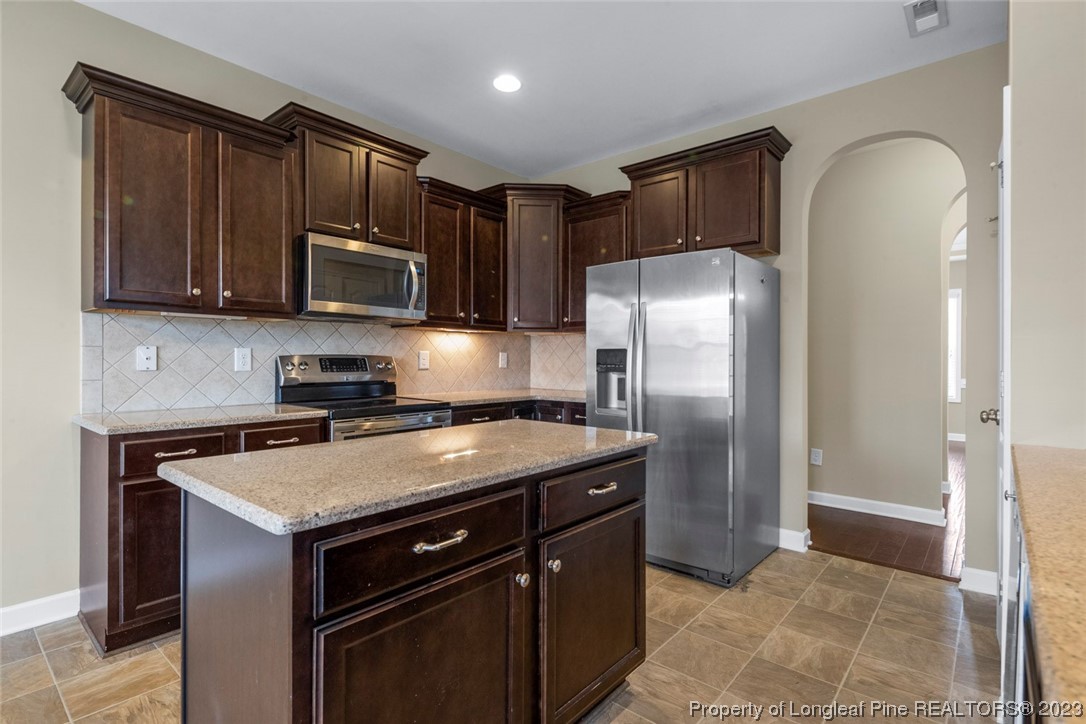 152 Copper Loop Sanford, NC 27332 - Photo 24 of 50 a kitchen with a stove sink and refrigerator