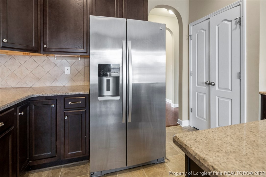 152 Copper Loop Sanford, NC 27332 - Photo 28 of 50 a kitchen with stainless steel appliances granite countertop a refrigerator and a sink