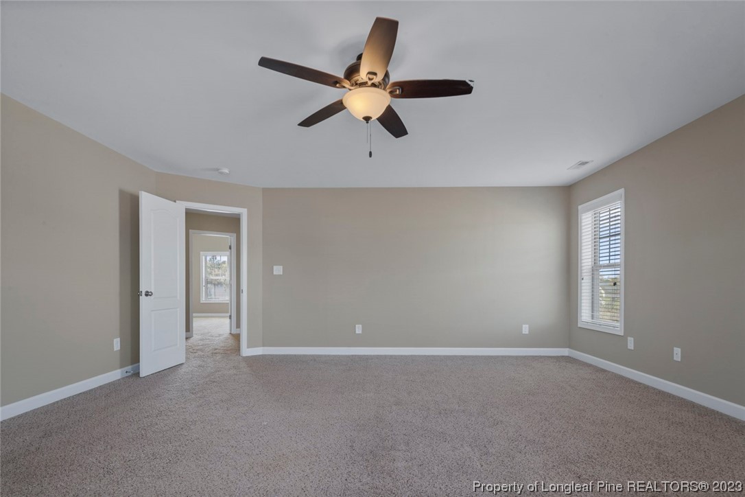 152 Copper Loop Sanford, NC 27332 - Photo 38 of 50 a view of a livingroom with a ceiling fan and window