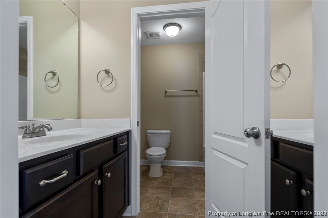 152 Copper Loop Sanford, NC 27332 - Photo 41 of 50 a bathroom with a granite countertop sink toilet and shower