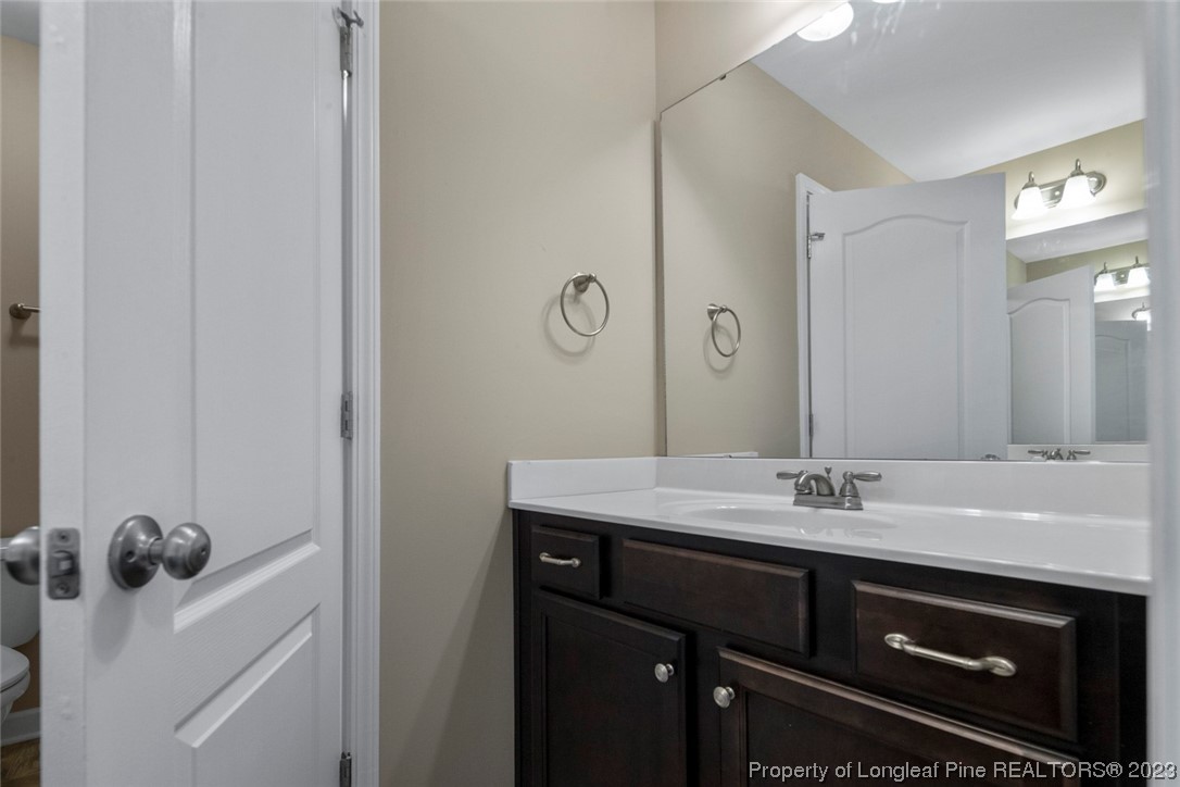 152 Copper Loop Sanford, NC 27332 - Photo 43 of 50 a bathroom with a sink and a mirror