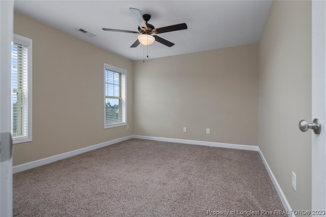 152 Copper Loop Sanford, NC 27332 - Photo 48 of 50 an empty room with a window and a fan
