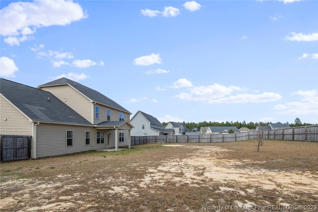 152 Copper Loop Sanford, NC 27332 - Photo 9 of 50 a view of a house next to a lake with a big yard