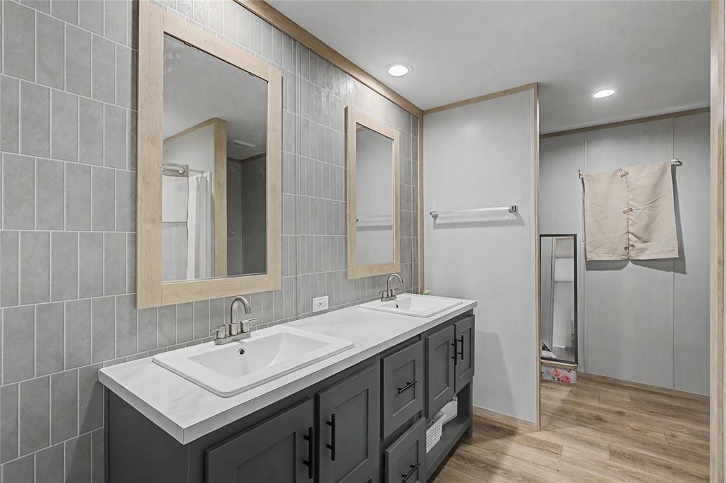 6065 Timber Trail Azle, TX 76020 - Photo 17 of 33 a bathroom with a sink and a mirror